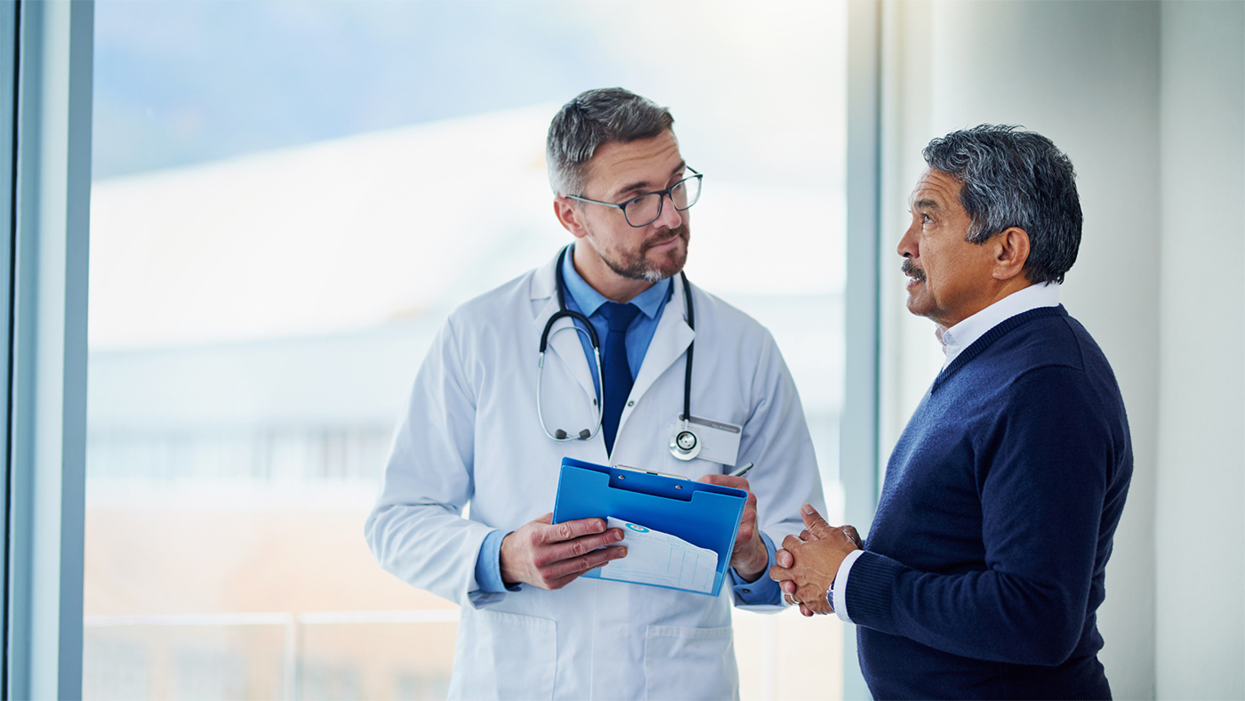 A men's health doctor speaking with a patient