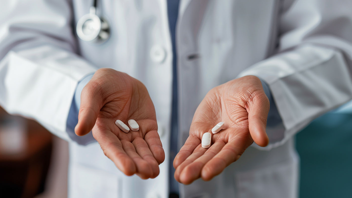 doctor showing generic medications in one hand and brand name drugs in the other